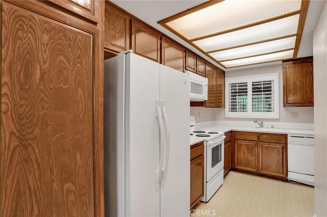 3486 Bahia Blanca W Unit 3F, Laguna Woods, CA 92637 - kitchen featuring white appliances, brown cabinets, light countertops, and light floors