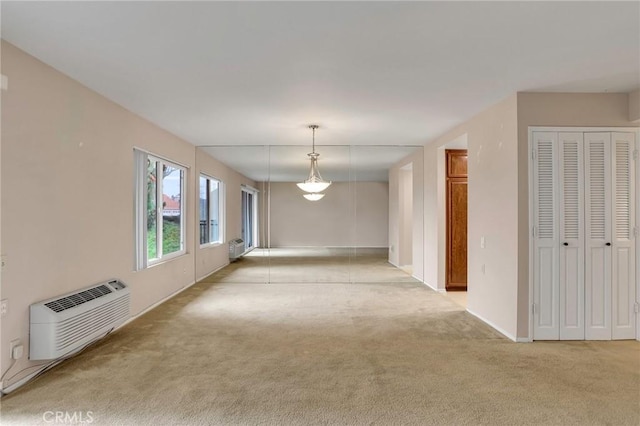 3486 Bahia Blanca W Unit 3F, Laguna Woods, CA 92637 - carpeted spare room featuring a wall mounted AC and baseboards