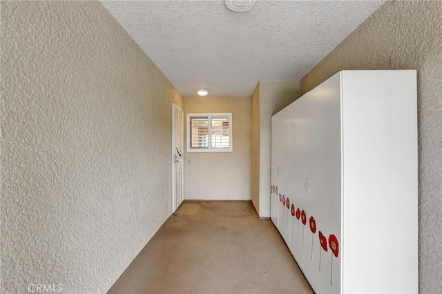 3486 Bahia Blanca W Unit 3F, Laguna Woods, CA 92637 - hallway featuring a textured wall, a textured ceiling, and light carpet