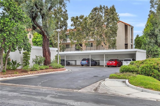 3486 Bahia Blanca W Unit 3F, Laguna Woods, CA 92637 - view of building exterior featuring covered parking
