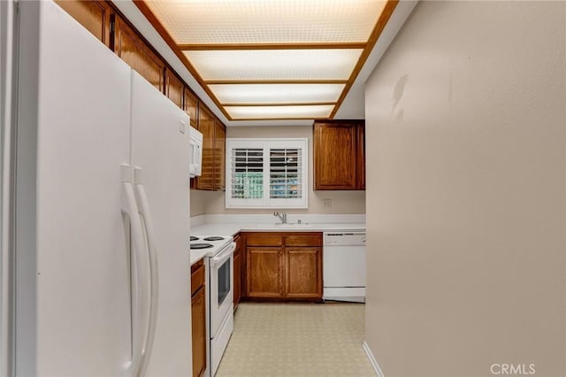 3486 Bahia Blanca W Unit 3F, Laguna Woods, CA 92637 - kitchen featuring white appliances, brown cabinetry, light countertops, and light flooring