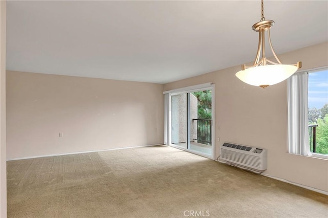 3486 Bahia Blanca W Unit 3F, Laguna Woods, CA 92637 - spare room with carpet flooring, healthy amount of natural light, and a wall unit AC