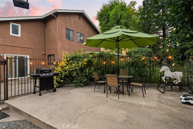 24825 Florence Ave, Corning, CA 96021 - patio terrace at dusk featuring a patio, outdoor dining area, and area for grilling