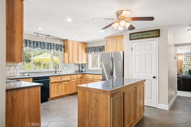 24825 Florence Ave, Corning, CA 96021 - kitchen with freestanding refrigerator, black dishwasher, a ceiling fan, light tile patterned floors, and tasteful backsplash