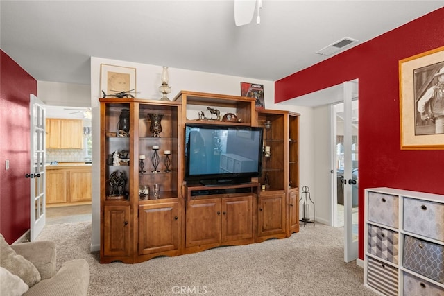24825 Florence Ave, Corning, CA 96021 - living area with ceiling fan, light colored carpet, and french doors