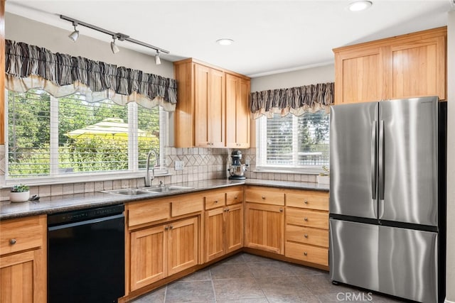 24825 Florence Ave, Corning, CA 96021 - kitchen featuring freestanding refrigerator, black dishwasher, tasteful backsplash, tile patterned floors, and healthy amount of natural light