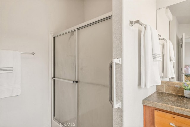 24825 Florence Ave, Corning, CA 96021 - bathroom featuring an enclosed shower, vanity, and decorative backsplash