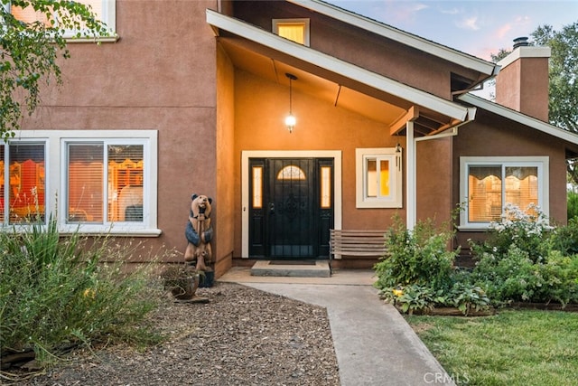 24825 Florence Ave, Corning, CA 96021 - doorway to property with stucco siding, a chimney, and a porch