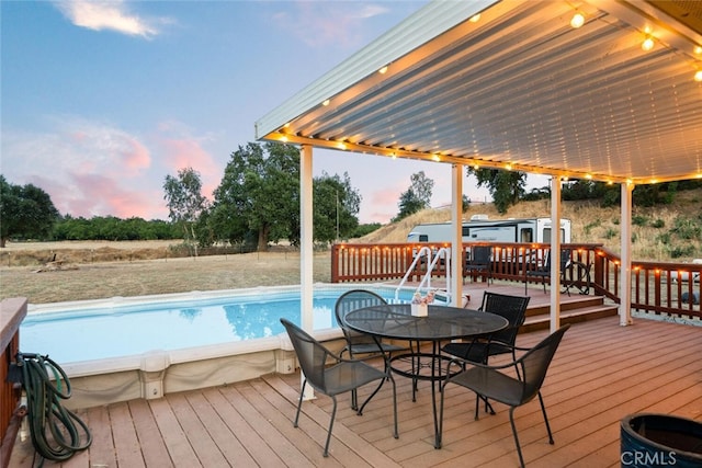 24825 Florence Ave, Corning, CA 96021 - wooden deck featuring an outdoor pool and outdoor dining area