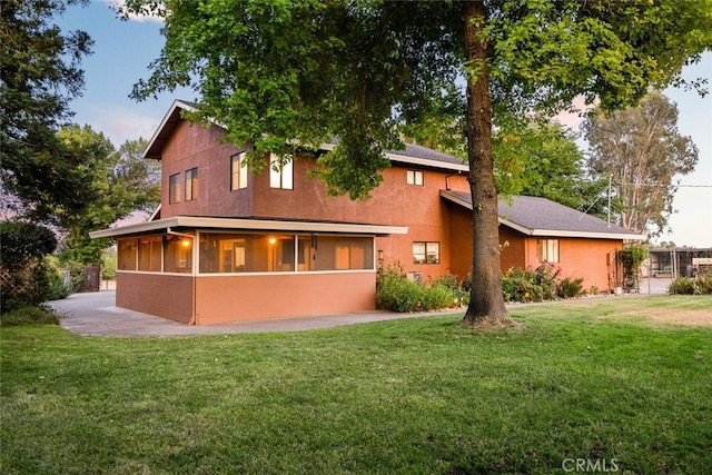24825 Florence Ave, Corning, CA 96021 - rear view of property featuring a lawn, a sunroom, and stucco siding