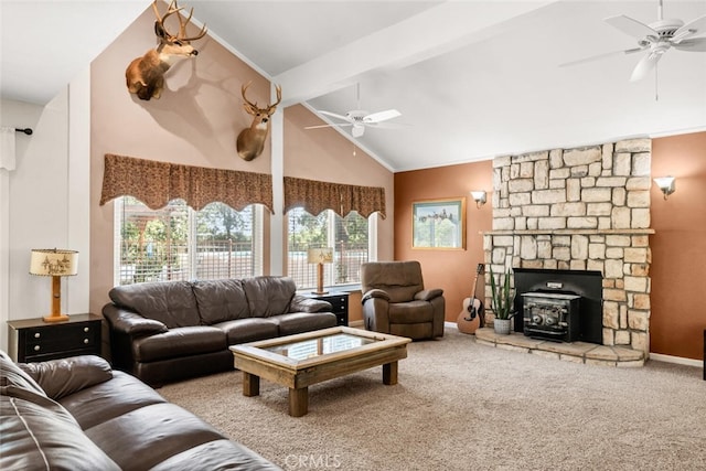 24825 Florence Ave, Corning, CA 96021 - living room featuring a ceiling fan, a wood stove, healthy amount of natural light, carpet flooring, and high vaulted ceiling