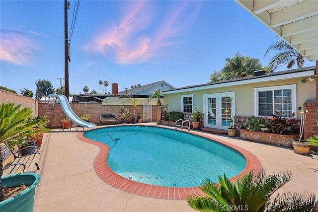 665 N Waterbury Ave, Covina, CA 91722 - view of swimming pool featuring french doors, a water slide, a patio, and a fenced backyard