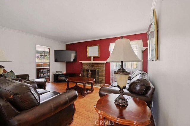 665 N Waterbury Ave, Covina, CA 91722 - living room featuring a fireplace, light wood-style flooring, and crown molding