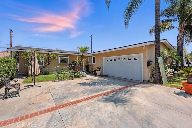 665 N Waterbury Ave, Covina, CA 91722 - ranch-style home with stucco siding, a garage, and concrete driveway