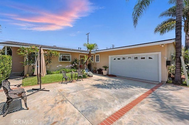 665 N Waterbury Ave, Covina, CA 91722 - ranch-style house with stucco siding, an attached garage, and driveway