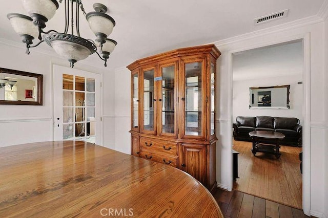 665 N Waterbury Ave, Covina, CA 91722 - dining area with dark wood-type flooring and crown molding
