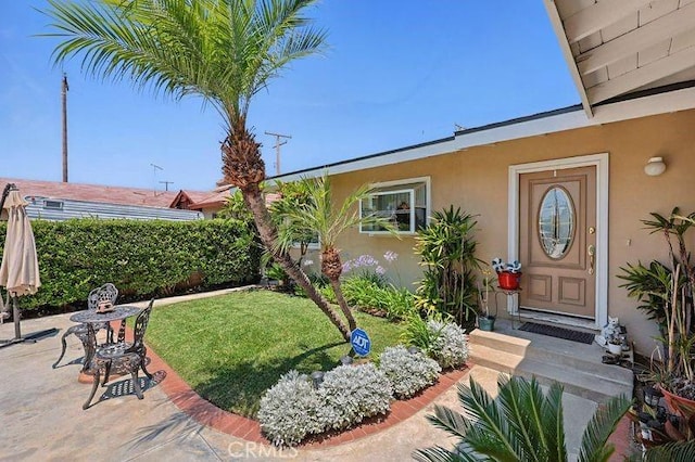 665 N Waterbury Ave, Covina, CA 91722 - property entrance featuring stucco siding, a yard, and a patio area