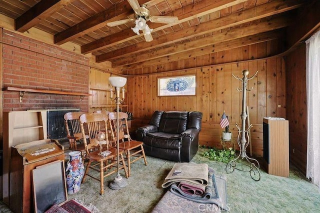 665 N Waterbury Ave, Covina, CA 91722 - living room featuring a wood ceiling with exposed beams, carpet, wooden walls, and ceiling fan