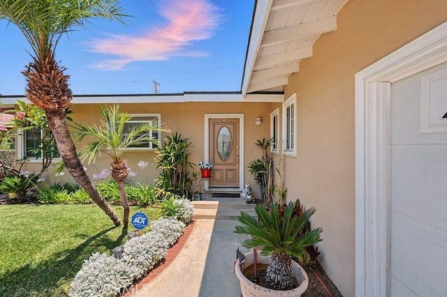 665 N Waterbury Ave, Covina, CA 91722 - doorway to property with stucco siding and a yard