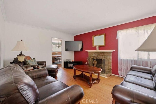 665 N Waterbury Ave, Covina, CA 91722 - living room featuring plenty of natural light, wood finished floors, a fireplace, and ornamental molding