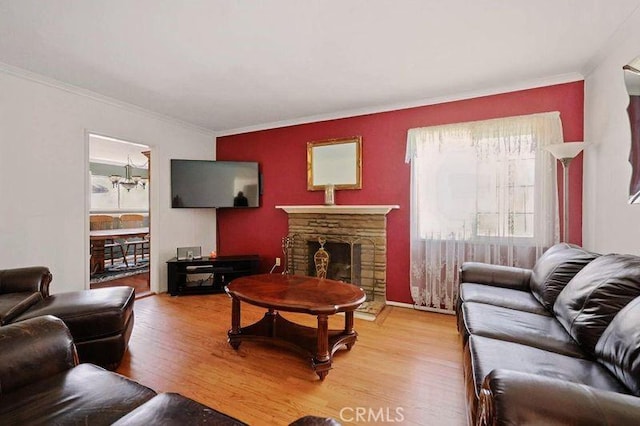 665 N Waterbury Ave, Covina, CA 91722 - living area with light wood-style flooring, ornamental molding, and a stone fireplace