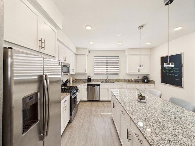 5502 Caminito Sandwaves Unit 173, San Diego, CA 92154 - kitchen with stainless steel appliances, white cabinetry, light wood-style flooring, light stone countertops, and recessed lighting