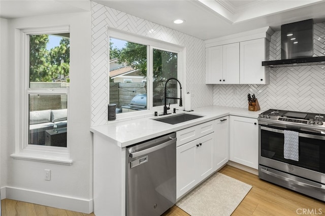 20 Marigold Unit 15, Irvine, CA 92614 - kitchen featuring stainless steel appliances, wall chimney range hood, crown molding, light countertops, and backsplash