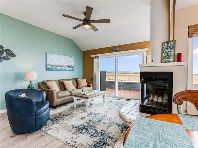 271 Vista Del Mar Unit 1, San Simeon, CA 93452 - living room with a ceiling fan, lofted ceiling, wood finished floors, and a multi sided fireplace