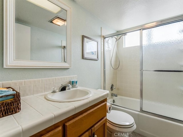 271 Vista Del Mar Unit 1, San Simeon, CA 93452 - bathroom featuring vanity, bath / shower combo with glass door, a textured wall, and a textured ceiling