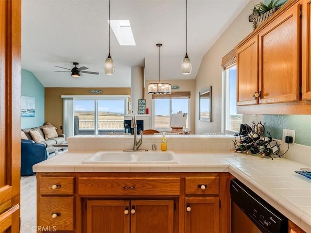 271 Vista Del Mar Unit 1, San Simeon, CA 93452 - kitchen featuring dishwasher, open floor plan, a skylight, vaulted ceiling, and brown cabinets