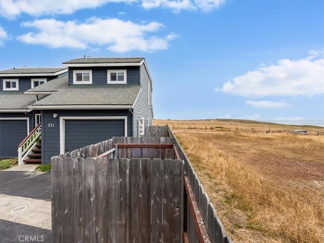 271 Vista Del Mar Unit 1, San Simeon, CA 93452 - view of front of house featuring roof with shingles and a garage