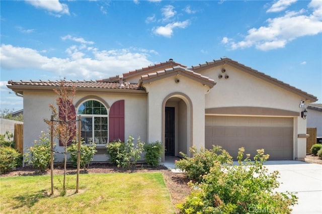 843 Sydney Way, Lemoore, CA 93245 - mediterranean / spanish-style home with an attached garage, stucco siding, driveway, a front lawn, and a tiled roof