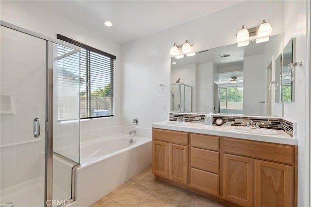 843 Sydney Way, Lemoore, CA 93245 - bathroom featuring a stall shower, double vanity, a garden tub, tasteful backsplash, and tile patterned floors