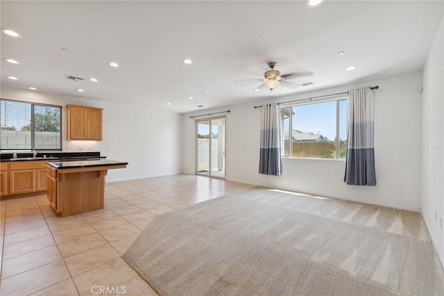 843 Sydney Way, Lemoore, CA 93245 - unfurnished living room featuring plenty of natural light, light tile patterned floors, recessed lighting, and ceiling fan
