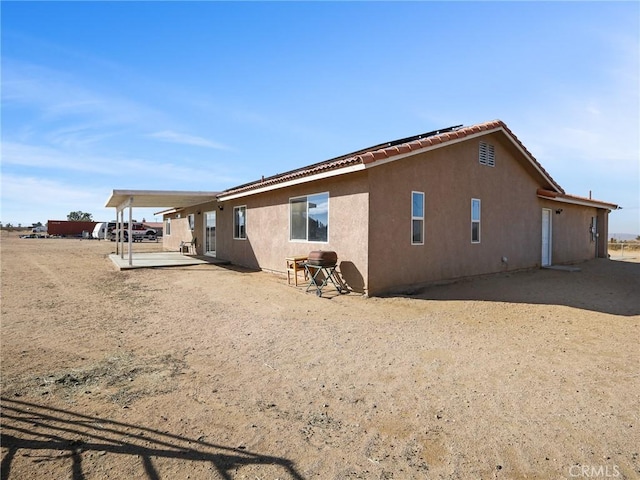 7755 7th St, Phelan, CA 92371 - rear view of property featuring stucco siding and a patio area