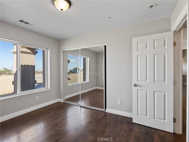 7755 7th St, Phelan, CA 92371 - unfurnished bedroom featuring a closet, wood finished floors, and a textured ceiling