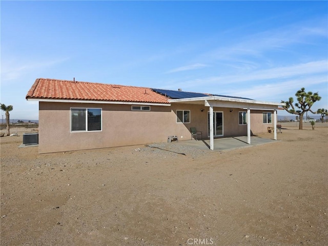 7755 7th St, Phelan, CA 92371 - rear view of house with stucco siding, a patio, and solar panels