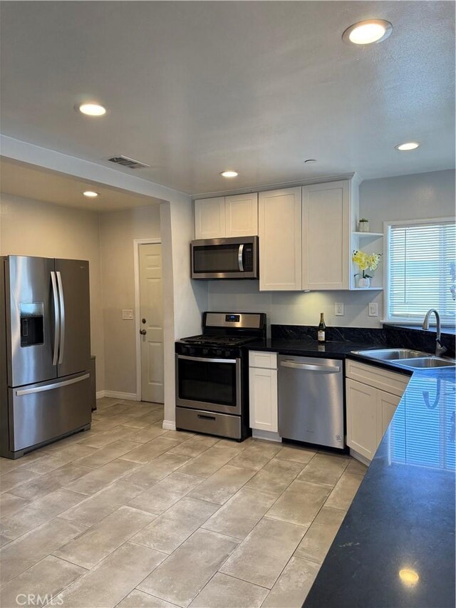 13906 S Kalsman Ave, Compton, CA 90222 - kitchen with stainless steel appliances, white cabinetry, open shelves, recessed lighting, and light tile patterned floors