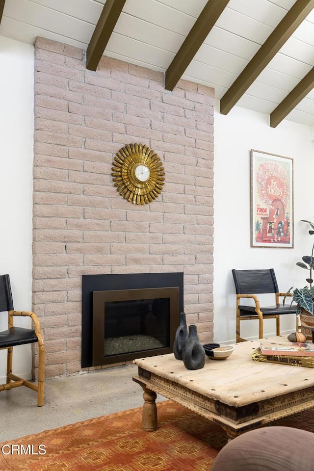 54667 Benecia Trl, Yucca Valley, CA 92284 - carpeted living area featuring beamed ceiling and a brick fireplace