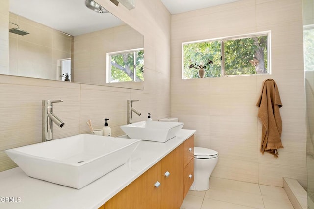 54667 Benecia Trl, Yucca Valley, CA 92284 - bathroom featuring tile walls, tile patterned floors, double vanity, and tiled shower