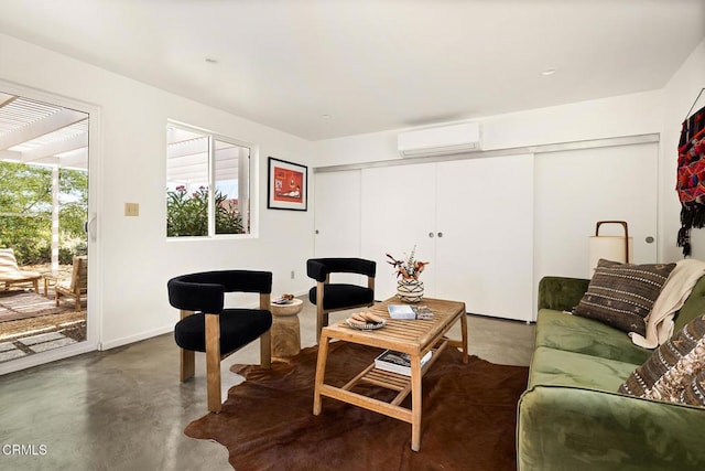 54667 Benecia Trl, Yucca Valley, CA 92284 - living room featuring a wall mounted air conditioner and finished concrete floors