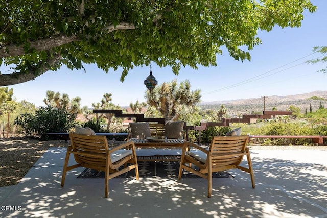 54667 Benecia Trl, Yucca Valley, CA 92284 - view of patio with a mountain view and outdoor dining area