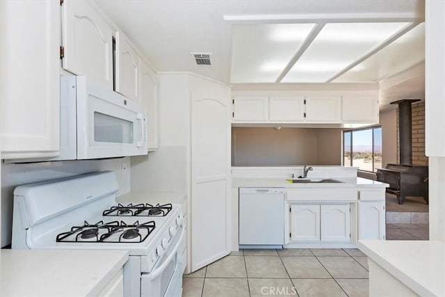 7267 Dalscote St, Hesperia, CA 92345 - kitchen featuring white appliances, white cabinetry, light tile patterned floors, and light countertops