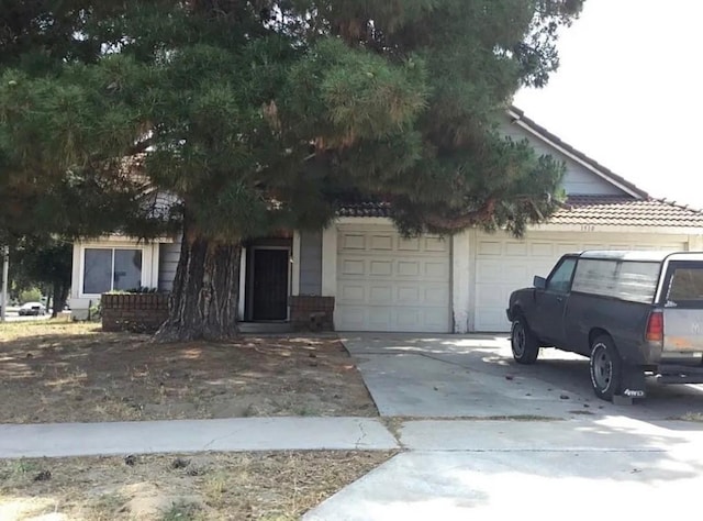 1510 Karon St, Redlands, CA 92374 - obstructed view of property with concrete driveway and a garage