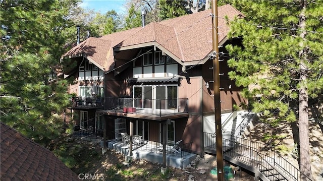 966 Willow Creek Rd Unit 14, Lake Arrowhead, CA 92352 - rear view of property featuring a shingled roof, a patio area, and stairway