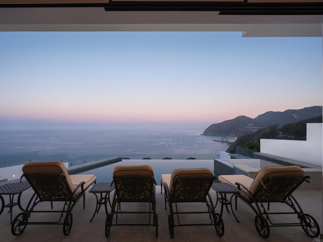 211 Mar De Cortez, Avalon, CA 90704 - patio terrace at dusk featuring a balcony, a water view, and an outdoor bar