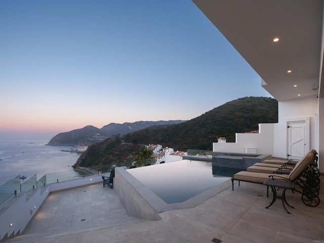 211 Mar De Cortez, Avalon, CA 90704 - pool at dusk featuring a water and mountain view and a patio