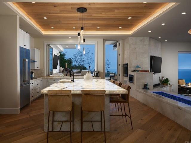 211 Mar De Cortez, Avalon, CA 90704 - kitchen with a raised ceiling, wood ceiling, dark wood finished floors, white cabinets, and recessed lighting