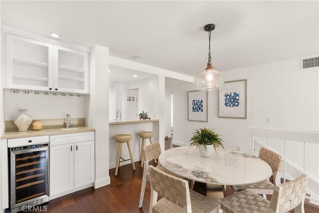 51 Sea Pine Ln, Newport Beach, CA 92660 - dining room featuring beverage cooler, bar with sink, dark wood finished floors, and recessed lighting