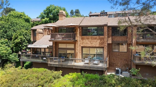 51 Sea Pine Ln, Newport Beach, CA 92660 - back of house featuring a balcony, a chimney, and a shingled roof
